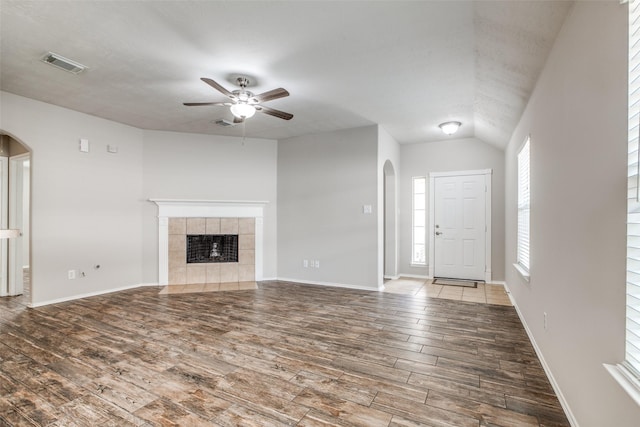 unfurnished living room featuring a fireplace, hardwood / wood-style floors, vaulted ceiling, and ceiling fan