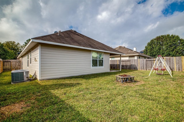 back of house featuring cooling unit and a yard