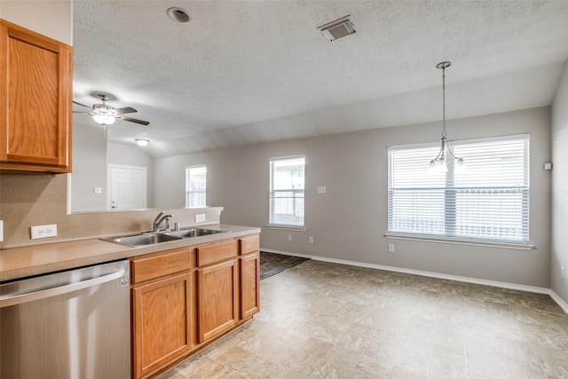 kitchen featuring ceiling fan, sink, hanging light fixtures, stainless steel dishwasher, and lofted ceiling