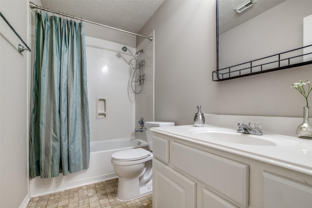 full bathroom featuring vanity, toilet, shower / bathtub combination with curtain, and a textured ceiling