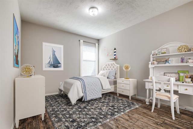 bedroom featuring dark hardwood / wood-style flooring and a textured ceiling