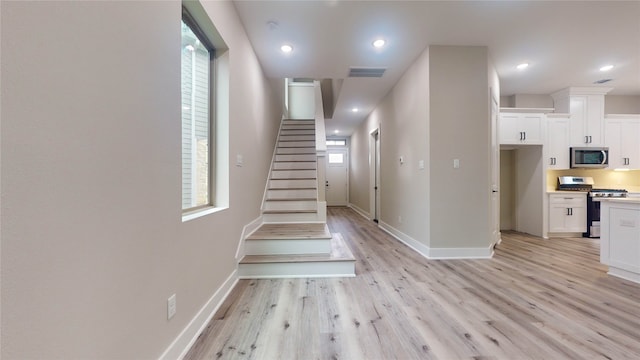 corridor with light hardwood / wood-style flooring