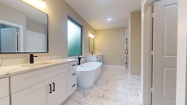 bathroom with tile floors, a bath to relax in, and vanity