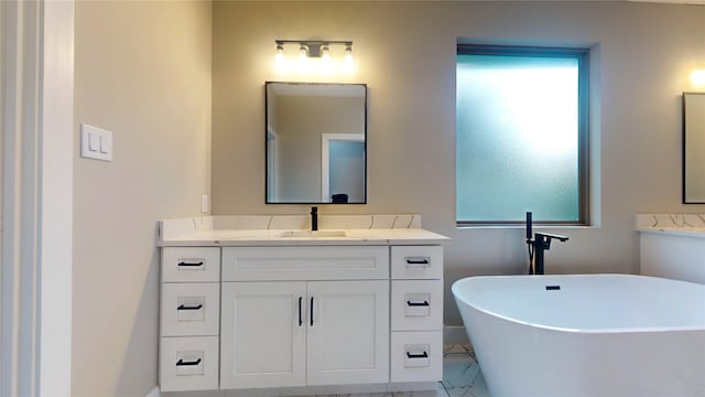 bathroom with a washtub, vanity, and tile floors