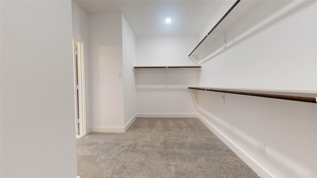 walk in closet with carpet floors