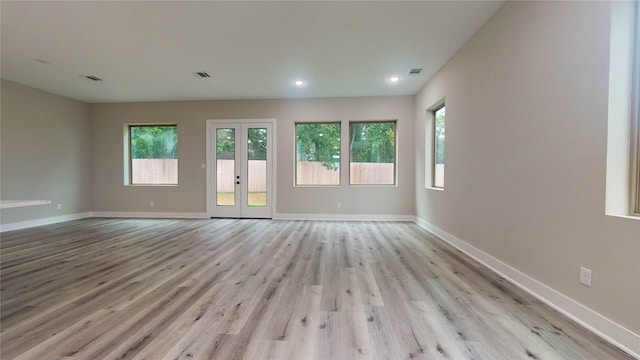 unfurnished room featuring light hardwood / wood-style flooring and french doors