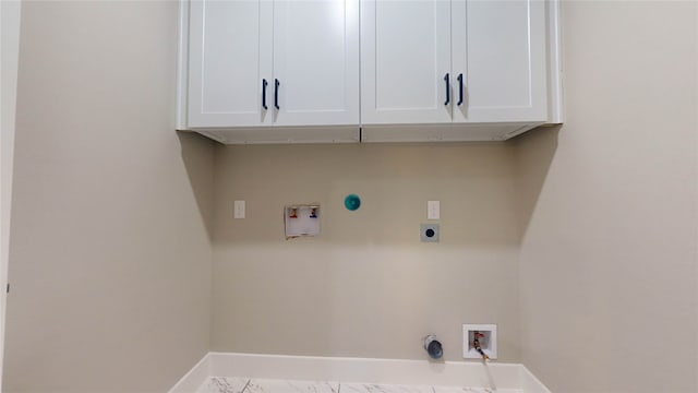 laundry area featuring hookup for a washing machine, cabinets, hookup for an electric dryer, and hookup for a gas dryer