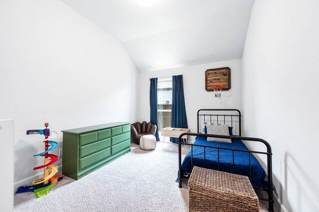 bedroom with vaulted ceiling and carpet floors