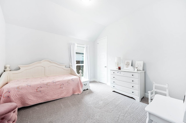 carpeted bedroom featuring vaulted ceiling