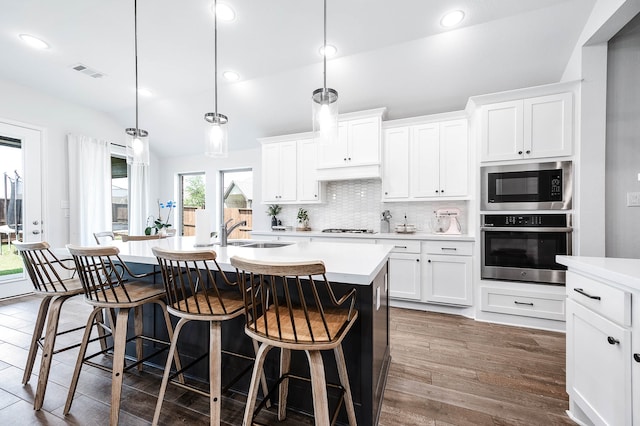 kitchen featuring sink, white cabinetry, oven, and built in microwave