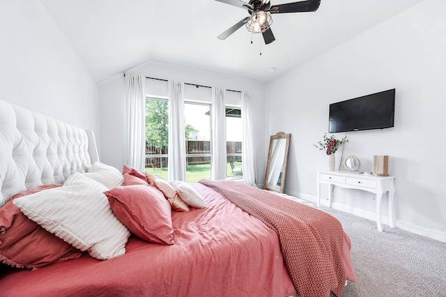 carpeted bedroom featuring ceiling fan and vaulted ceiling