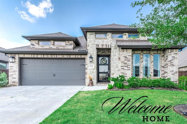 prairie-style home featuring a garage and a front lawn