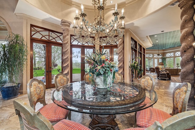 dining space with ornamental molding, an inviting chandelier, a high ceiling, and french doors