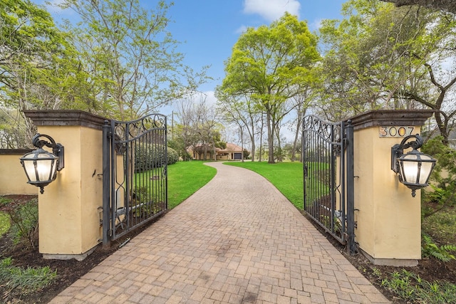 view of gate featuring a lawn