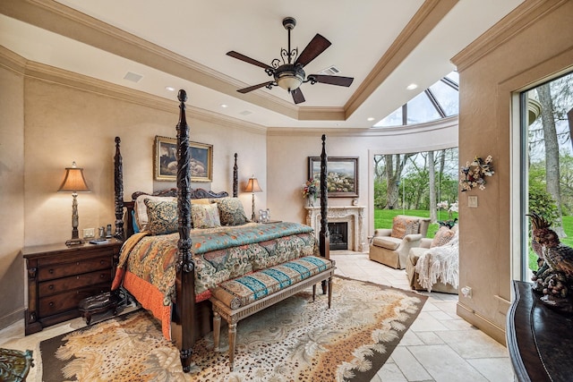 bedroom featuring ceiling fan, a tray ceiling, and crown molding