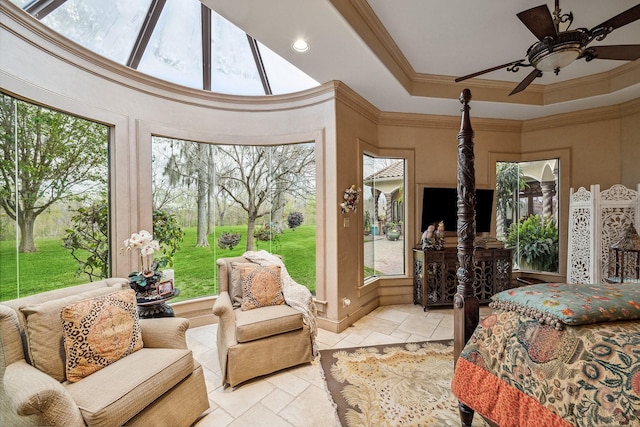 sunroom with a tray ceiling and ceiling fan