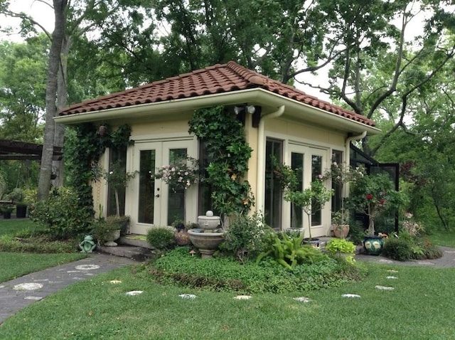 view of front facade featuring a front yard and french doors