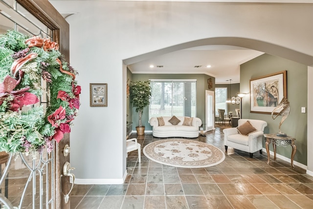 sitting room featuring crown molding and a chandelier