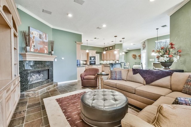 living room with crown molding and a fireplace