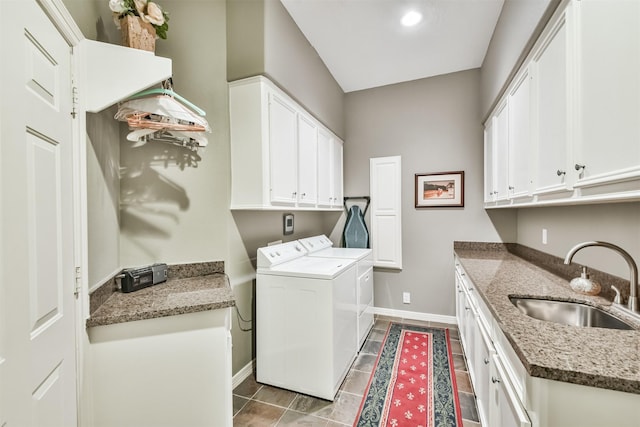 clothes washing area with tile patterned flooring, cabinets, sink, and washing machine and dryer