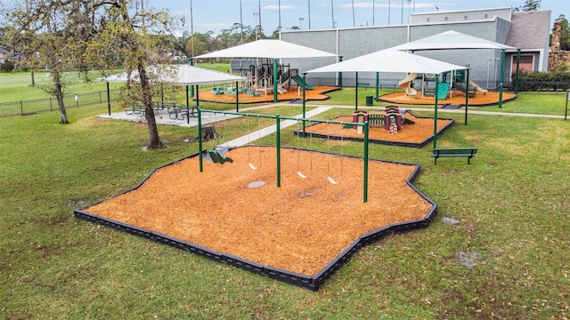 view of property's community featuring a yard and a playground