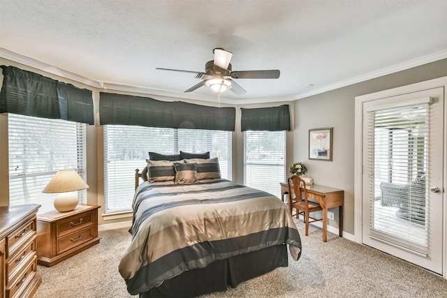 carpeted bedroom with access to exterior, ceiling fan, a textured ceiling, and ornamental molding