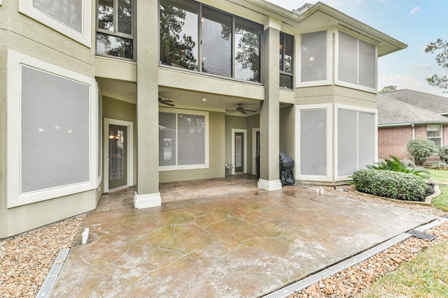 back of house with ceiling fan and a patio area