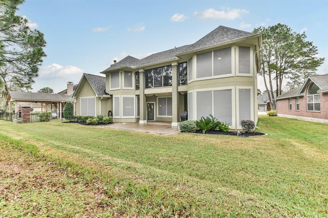 back of house with a lawn and a patio area