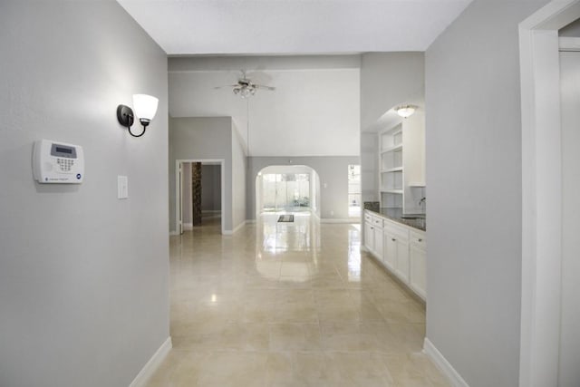 hall with sink and light tile floors