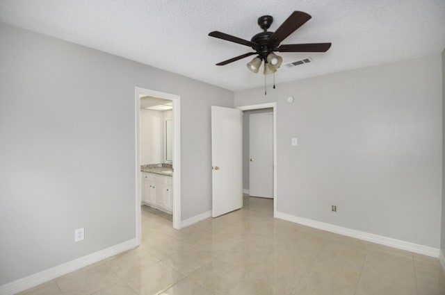 tiled spare room featuring ceiling fan and a textured ceiling