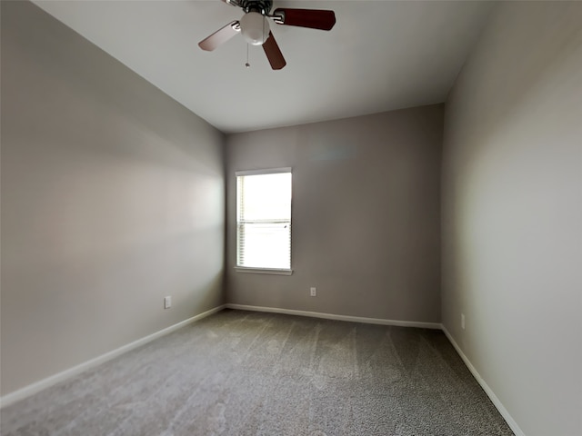 spare room featuring carpet flooring and ceiling fan