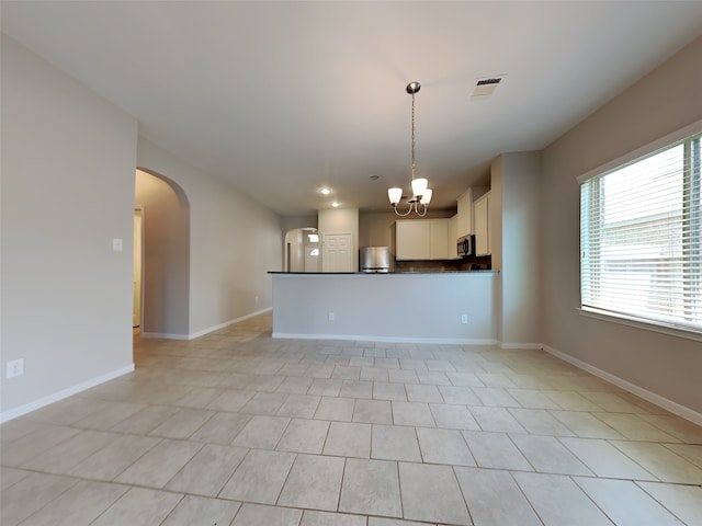 interior space with a notable chandelier and light tile patterned floors