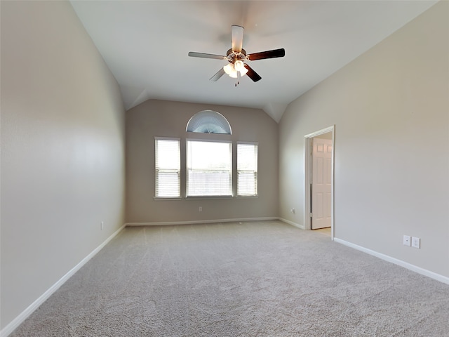 carpeted empty room featuring ceiling fan and vaulted ceiling