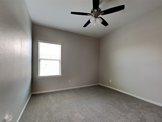 carpeted spare room featuring ceiling fan