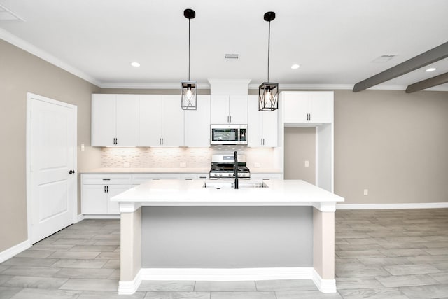 kitchen with white cabinetry, a kitchen island with sink, pendant lighting, and stainless steel appliances