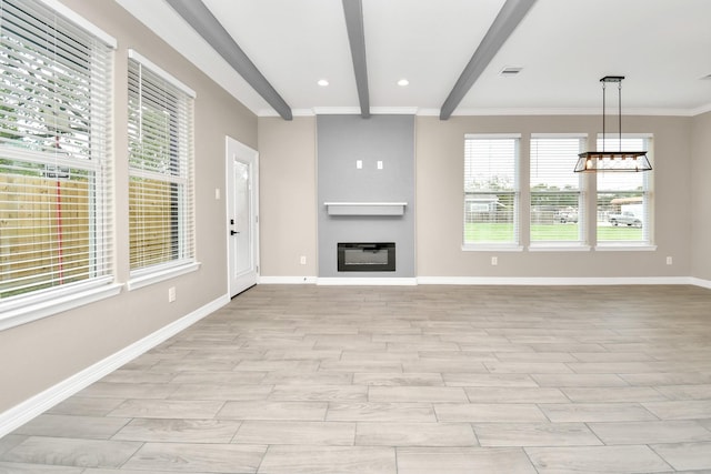 unfurnished living room with beam ceiling, heating unit, a wealth of natural light, and ornamental molding