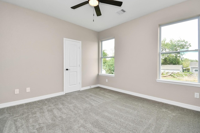 empty room featuring light carpet and ceiling fan