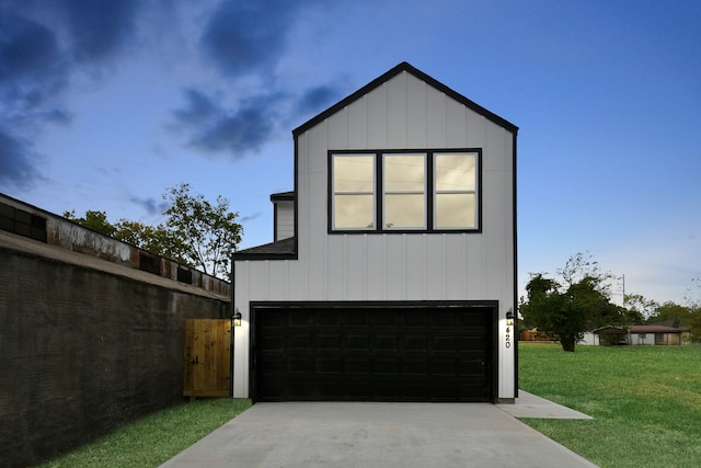 view of front of house with a garage and a front lawn