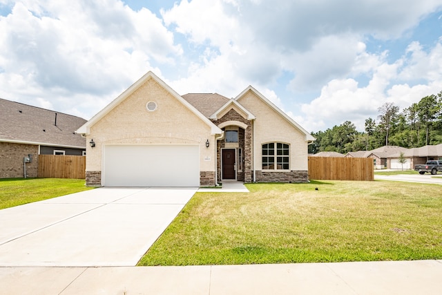 view of front of property featuring a garage and a front lawn