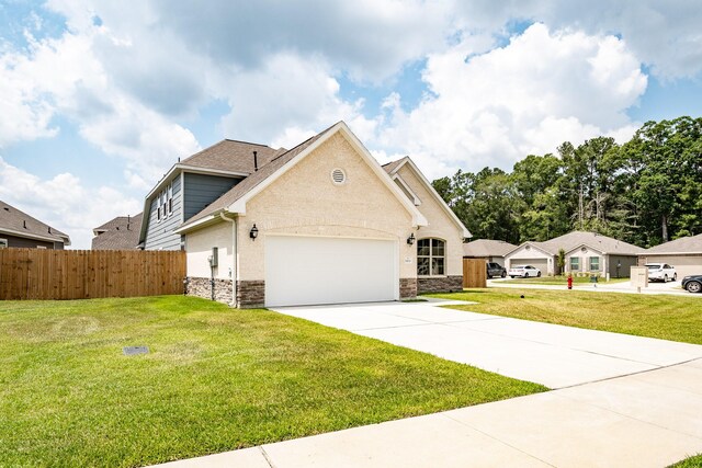 view of front of house with a garage and a front yard