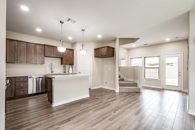 kitchen featuring dark brown cabinetry, recessed lighting, wood finished floors, a center island, and dishwasher