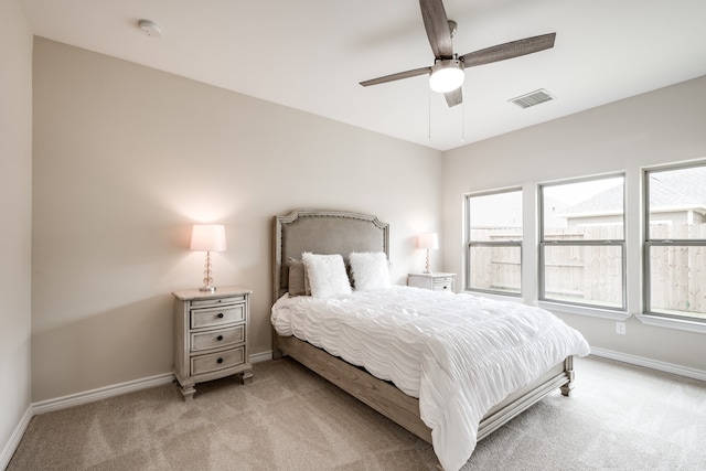 bedroom featuring light carpet and ceiling fan