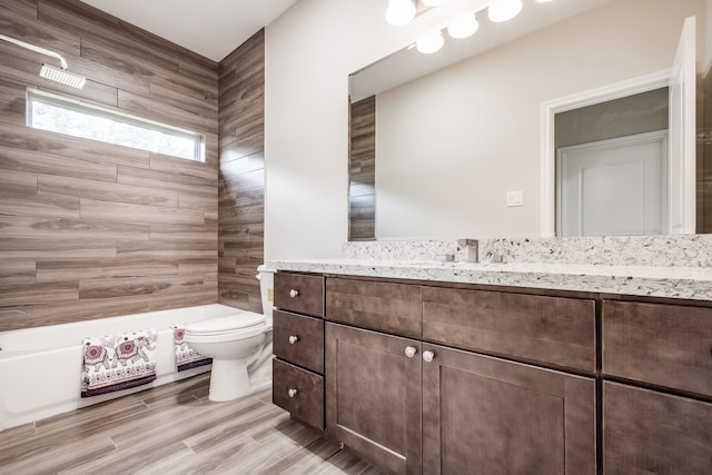 full bathroom with tiled shower / bath combo, toilet, and oversized vanity