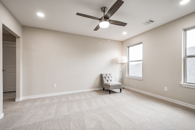 unfurnished room with light carpet and ceiling fan