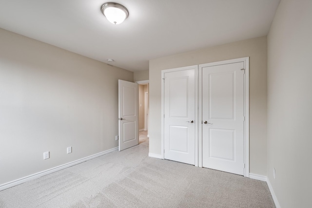 unfurnished bedroom featuring carpet and baseboards