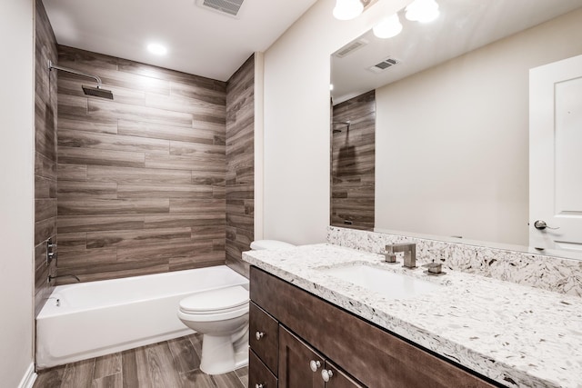 bathroom featuring visible vents, vanity, wood finished floors, and toilet