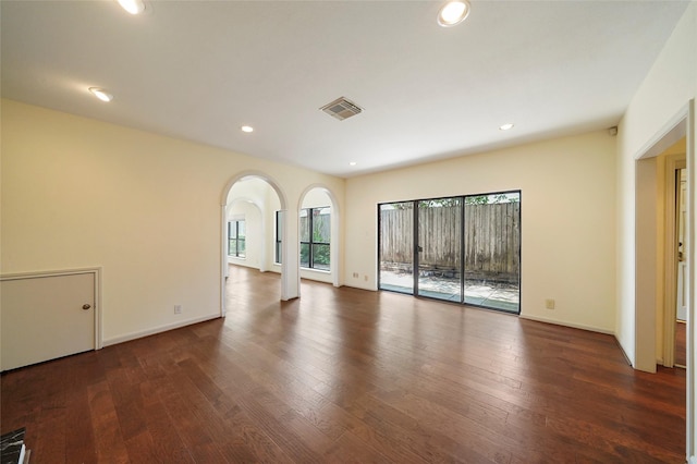 unfurnished living room featuring dark wood-type flooring