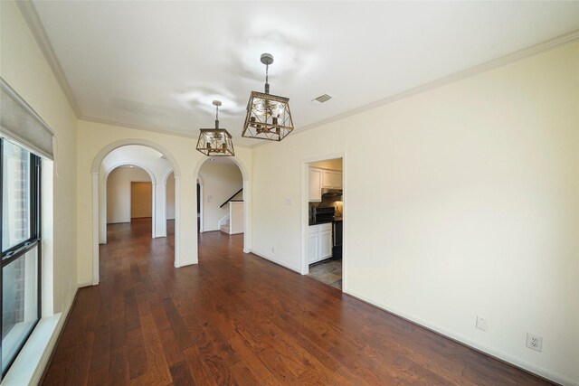 spare room with dark hardwood / wood-style floors and crown molding