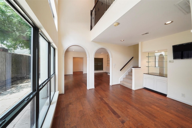 empty room with dark hardwood / wood-style flooring