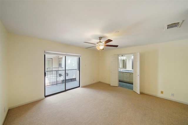 spare room with light carpet and ceiling fan